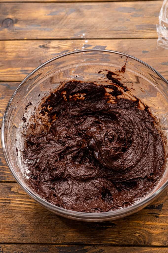 Glass bowl with chocolate cookie dough mixed in it.