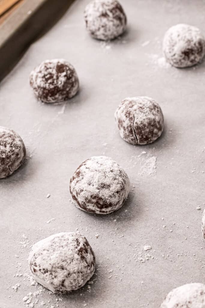 Dough balls of Chocolate Crinkle Cookies on baking sheet