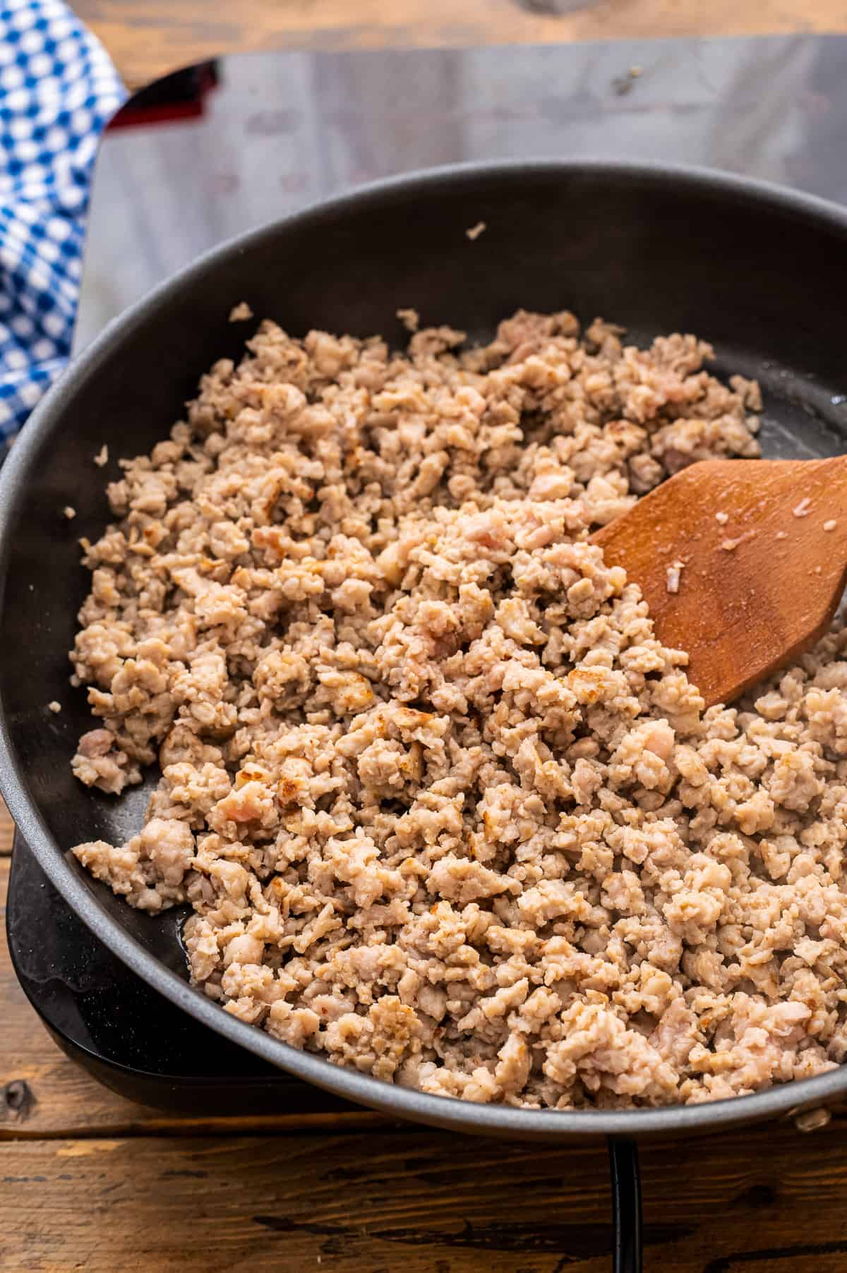 Cast Iron skillet with ground sausage being browned in it