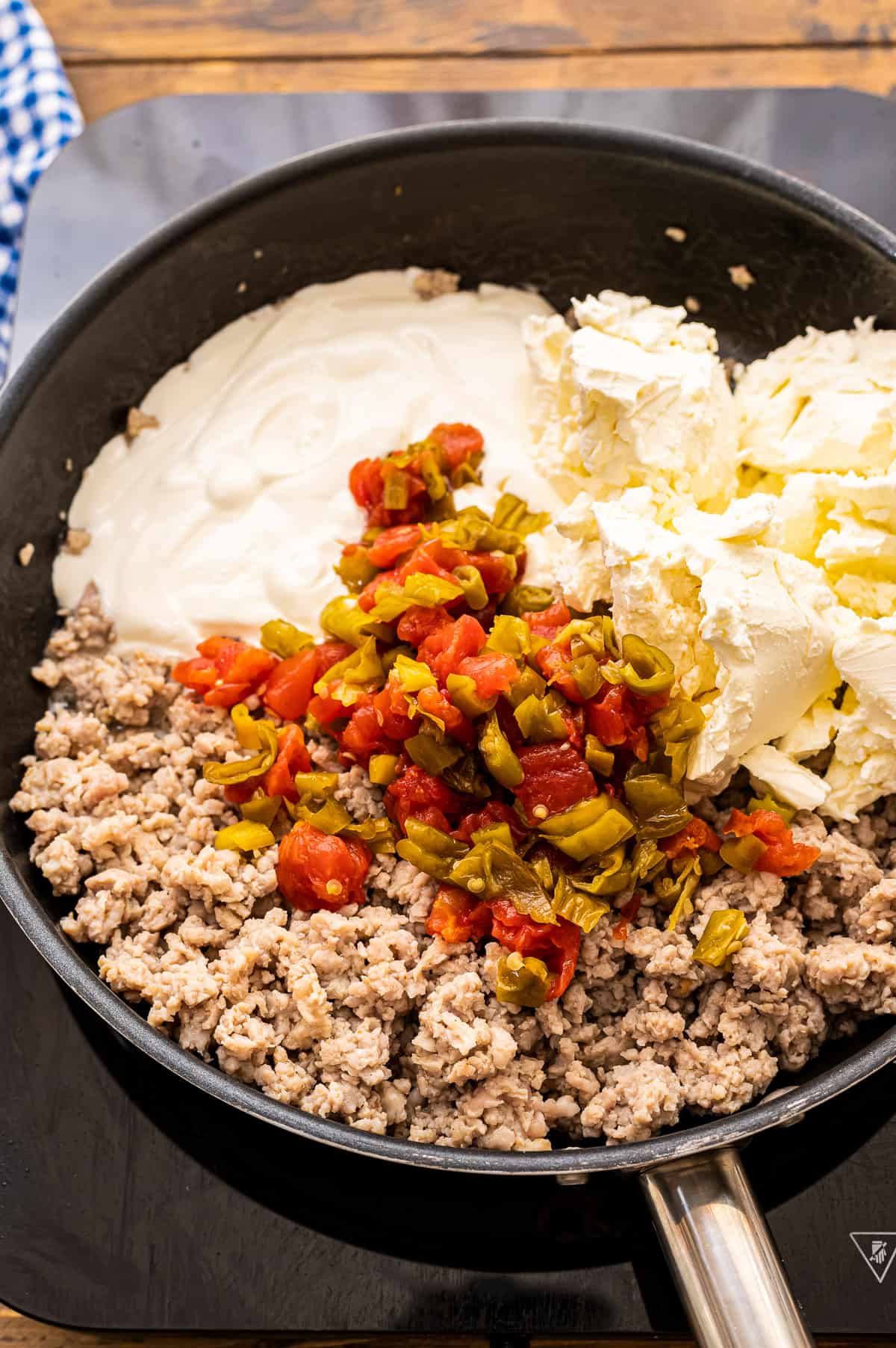 Ingredients for sausage dip in skillet before combining.