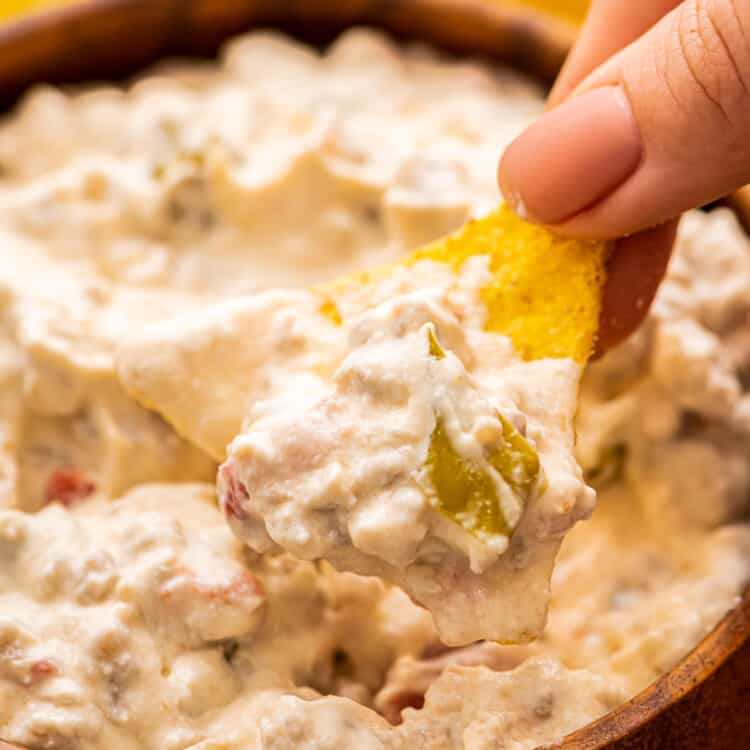 Tortilla Chip dipping into Sausage Dip