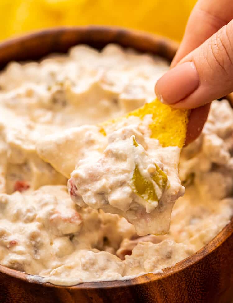 Tortilla Chip dipping into Sausage Dip