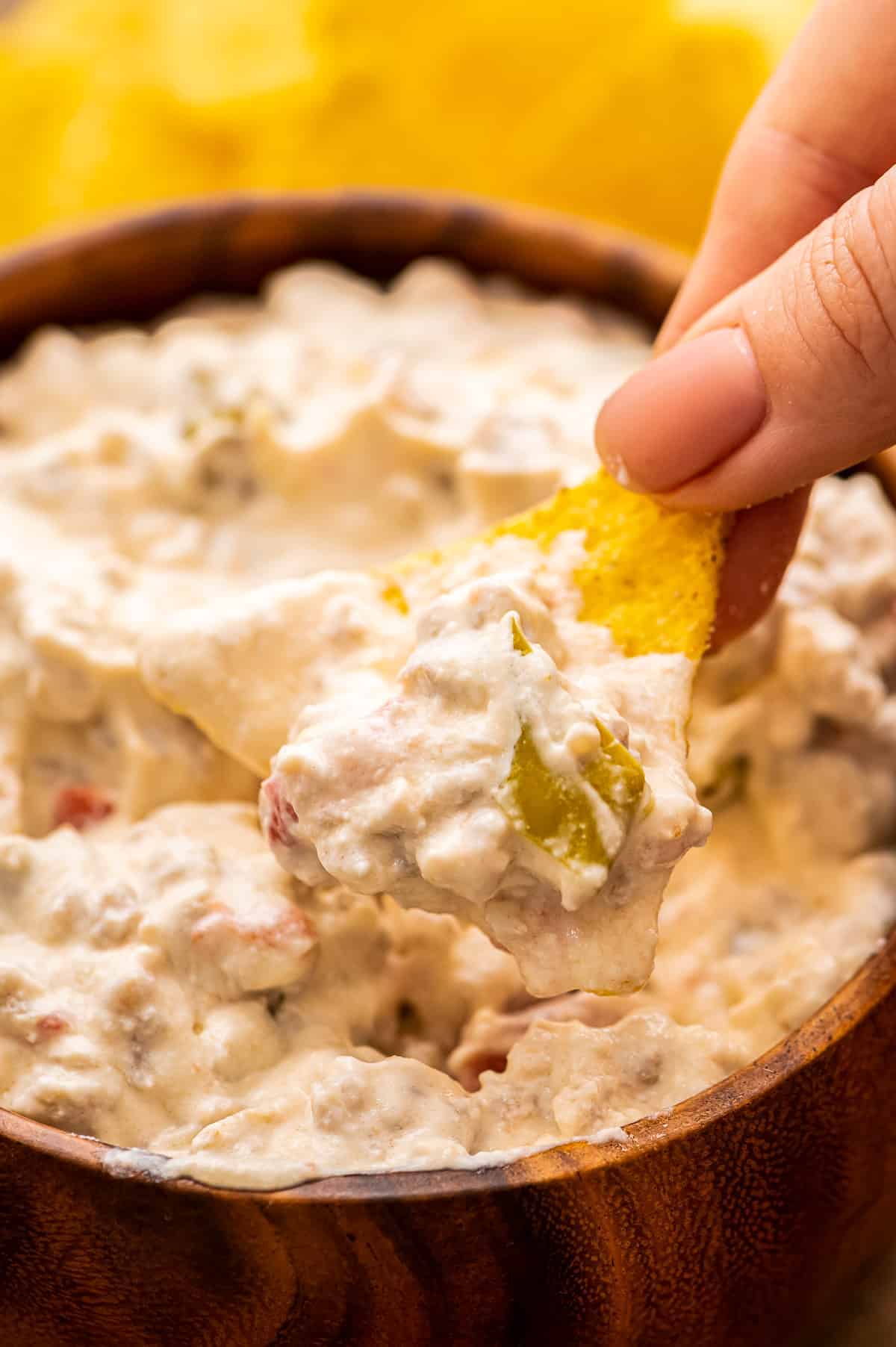 Tortilla Chip dipping into Sausage Dip