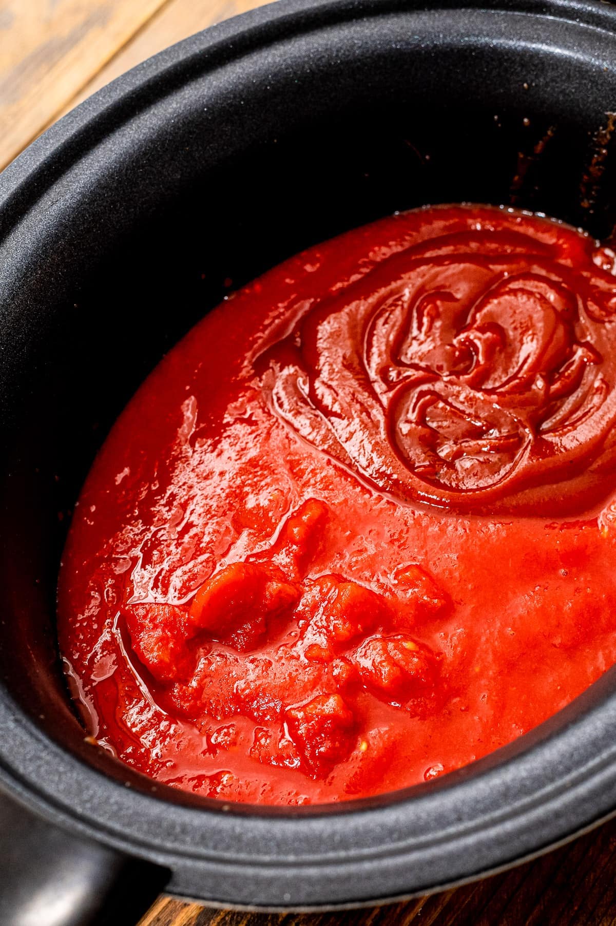 Crock pot with ingredients to make a spaghetti sauce