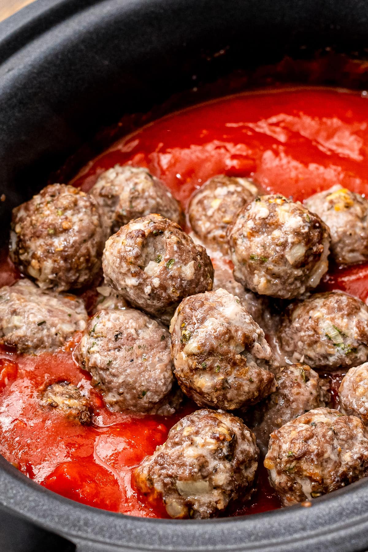 Crock Pot with sauce and meatballs in it.