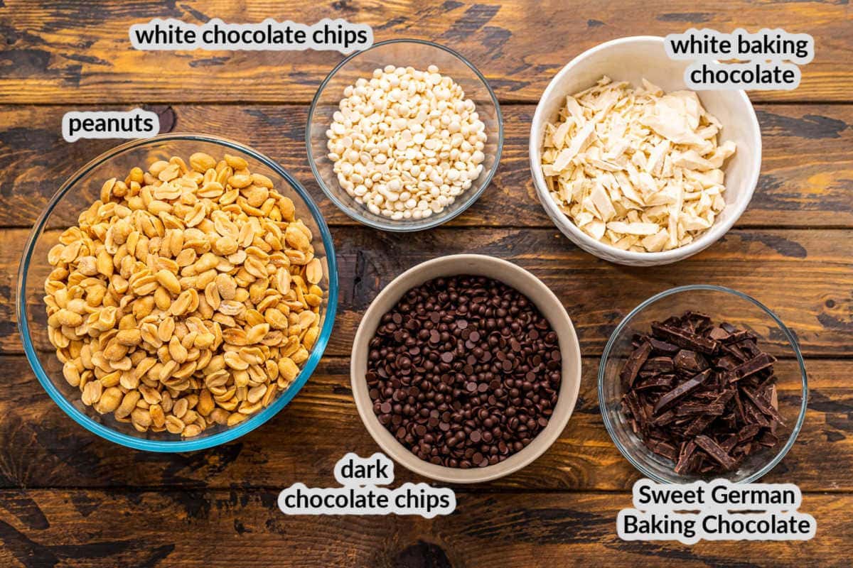 Crock Pot Peanut Clusters Ingredients in bowls on wooden background