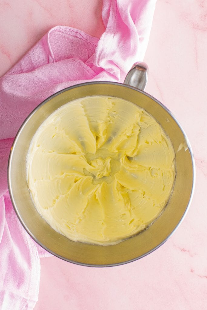 Creamed butter in metal stand mixing bowl