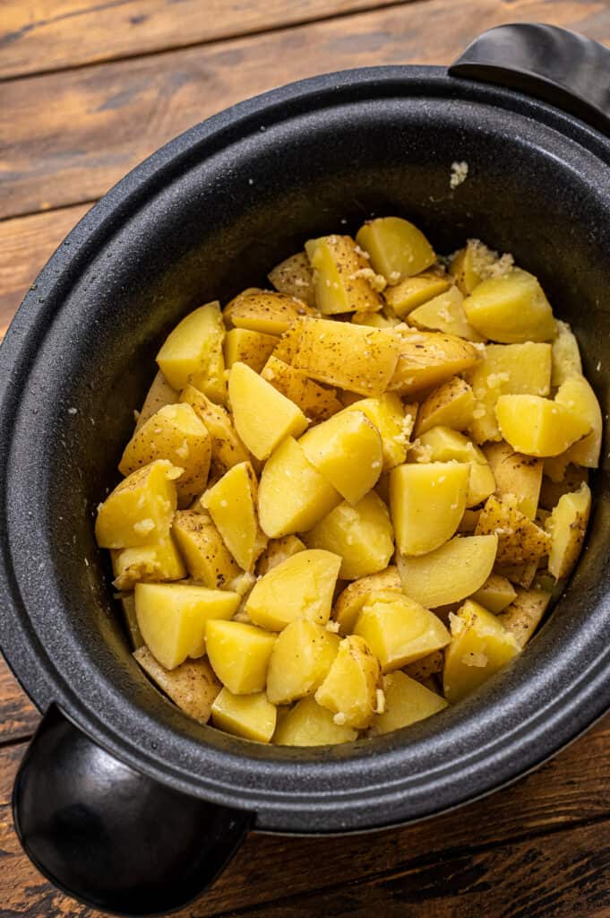Diced potatoes in black crock pot