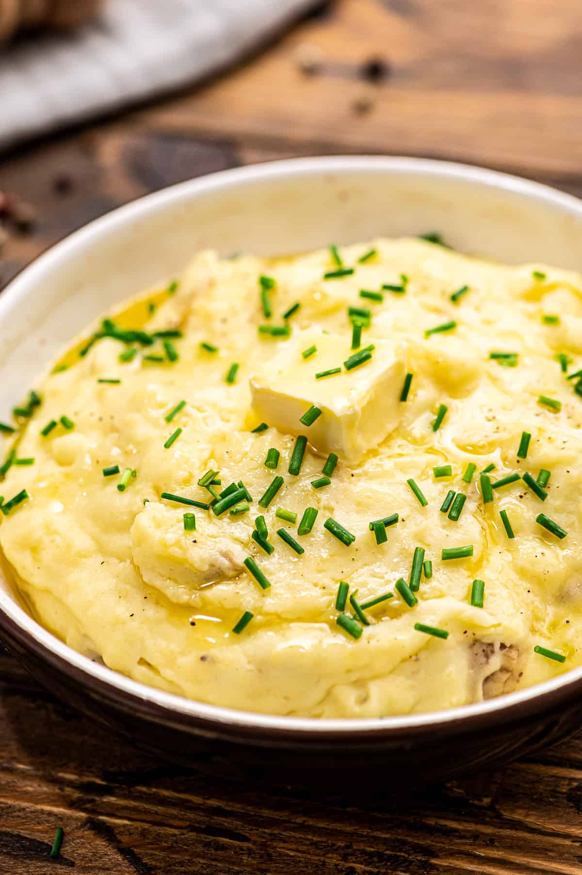 Garlic Crock Pot Mashed Potatoes in a bowl topped with chopped chives