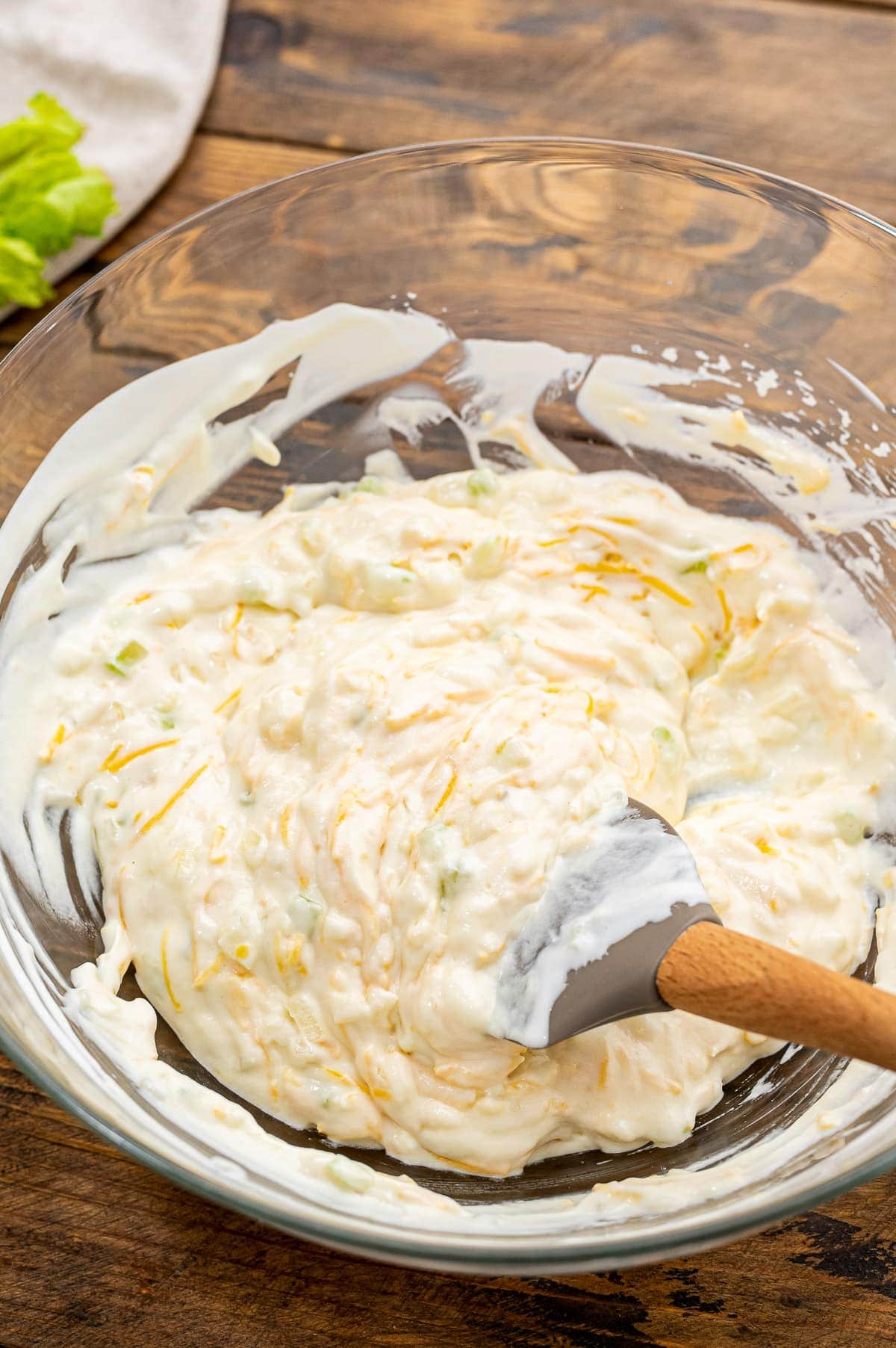 Glass bowl with soup mixture for green bean casserole after mixing