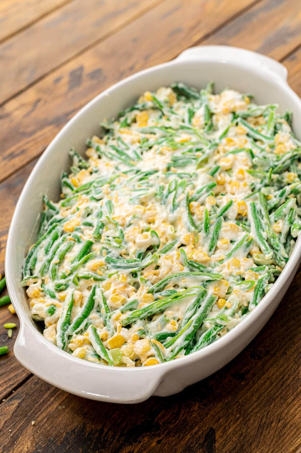 Green Bean Corn Casserole in white baking dish before baking