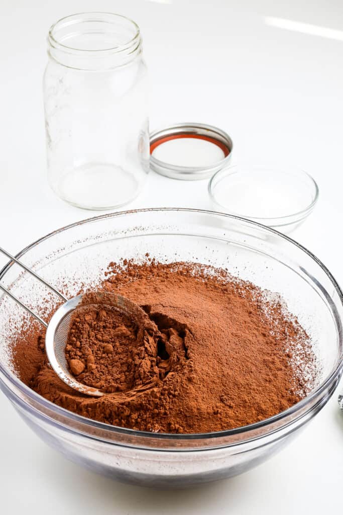 Glass bowl with cocoa powder in it.