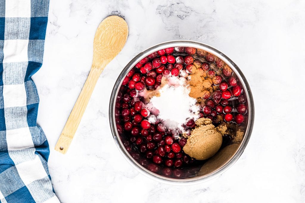 Instant Pot with ingredients in it to make cranberry sauce before mixing