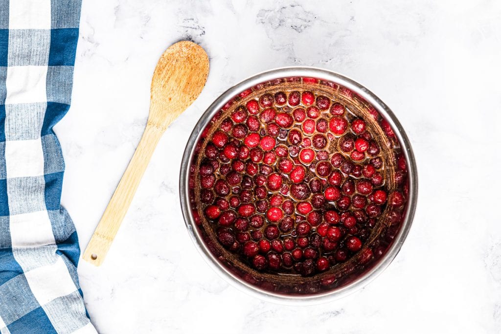 Instant Pot with ingredients in it to make cranberry sauce after mixing