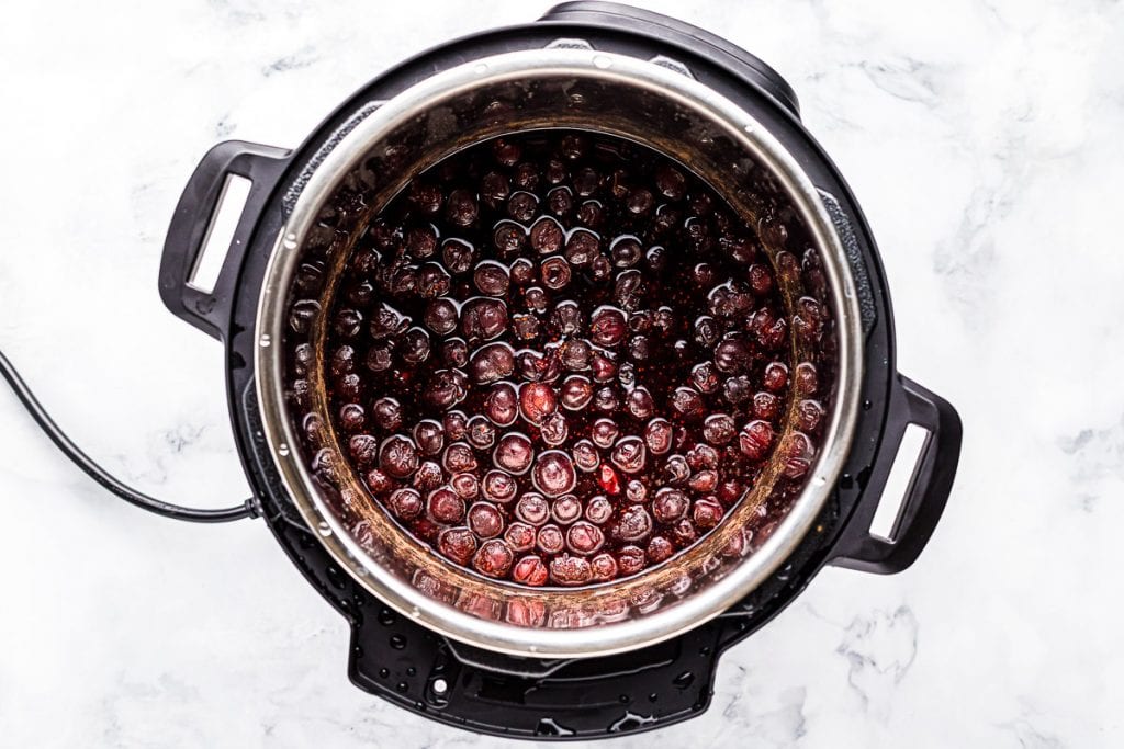 Instant Pot with ingredients in it to make cranberry sauce before cooking.