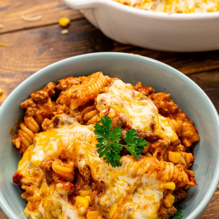 Mexican Pasta Bake in blue bowl topped with parsley