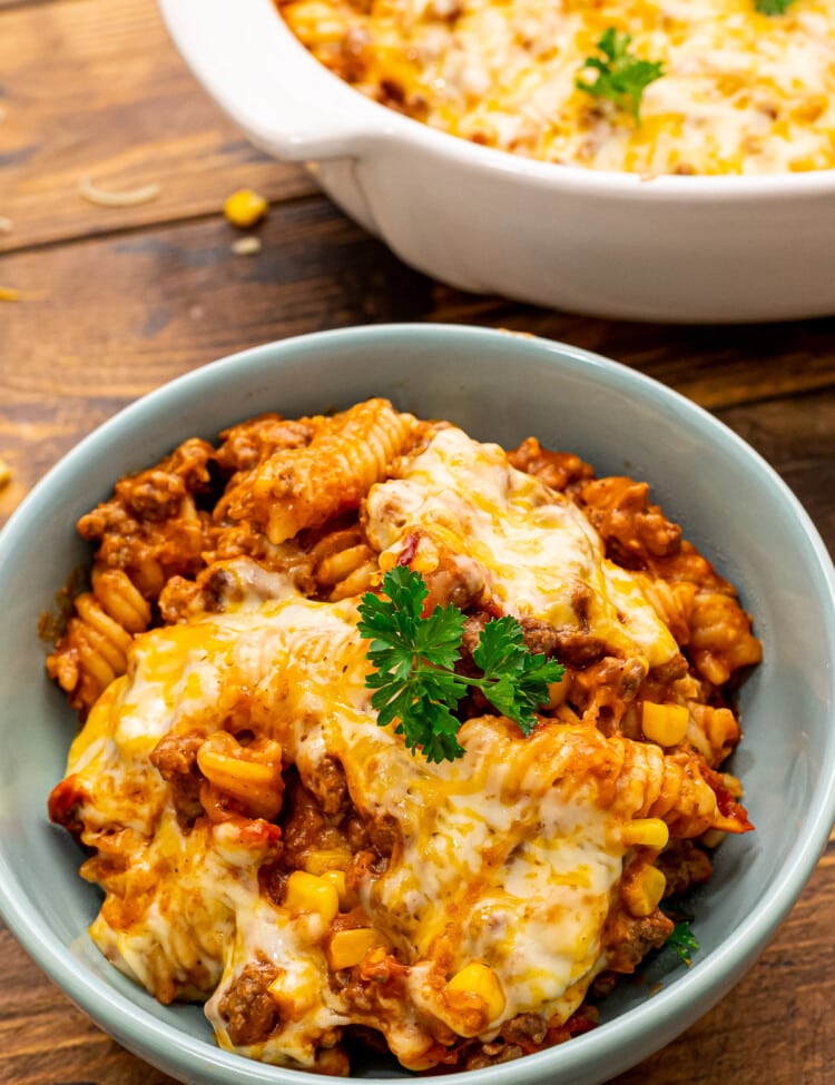 Mexican Pasta Bake in blue bowl topped with parsley