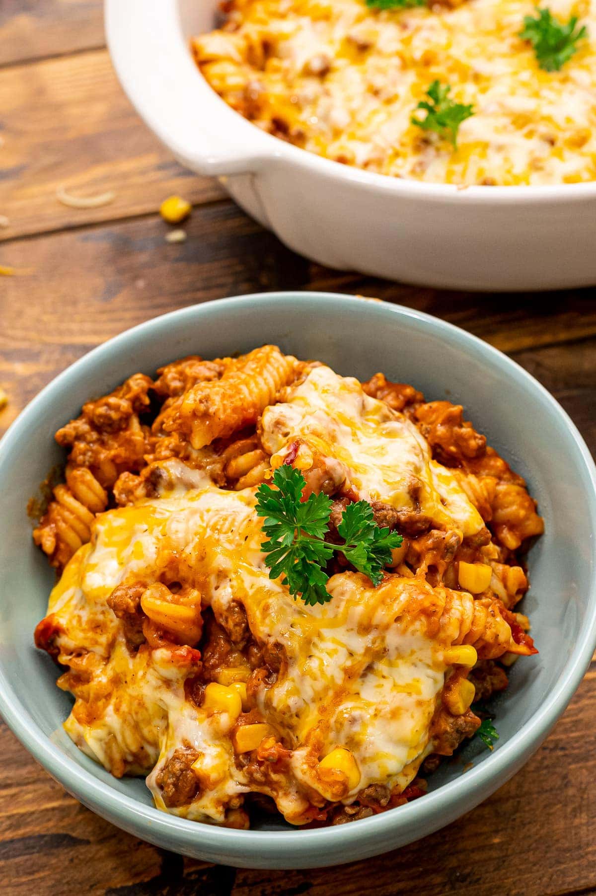 Mexican Pasta Bake in blue bowl topped with parsley