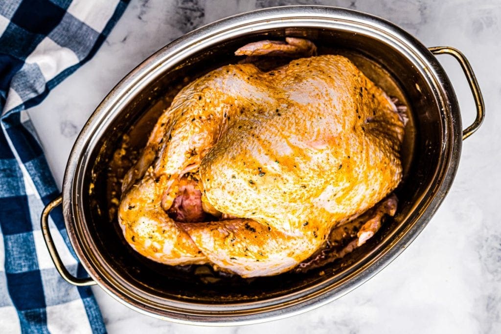 Turkey in pan that has been rubbed with butter, oil and seasonings