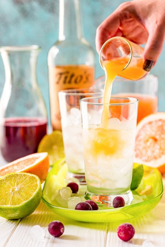 Pouring grapefruit juice into cocktail