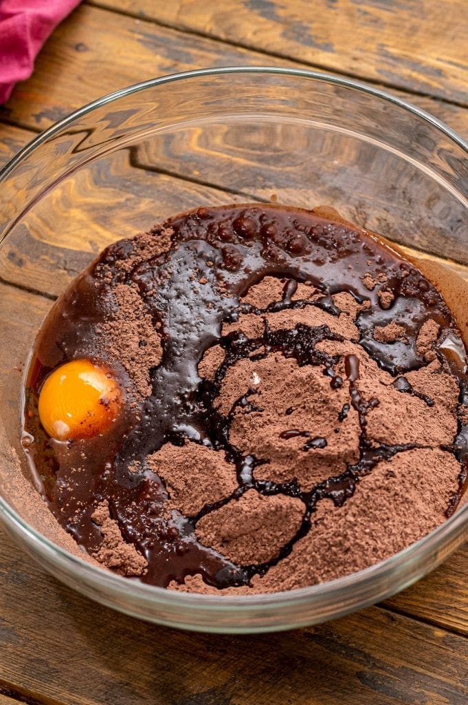 Glass bowl with ingredients to make chocolate brownie cookies