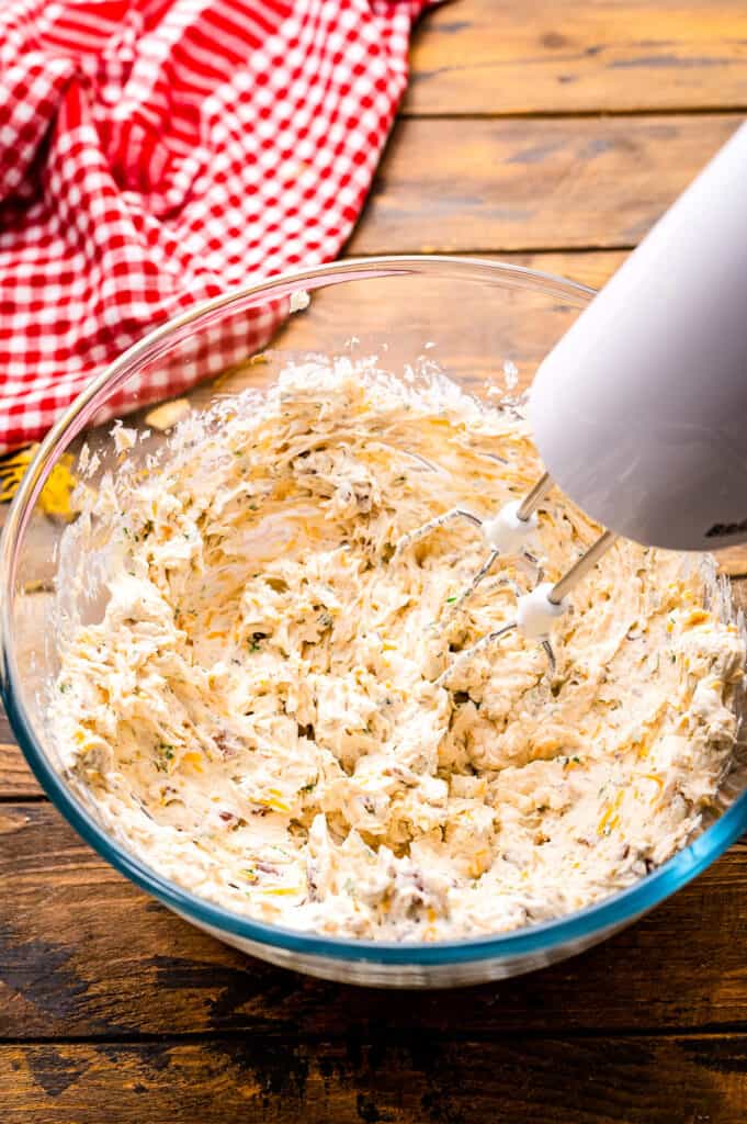 Mixer creaming cheese ball ingredients together in bowl