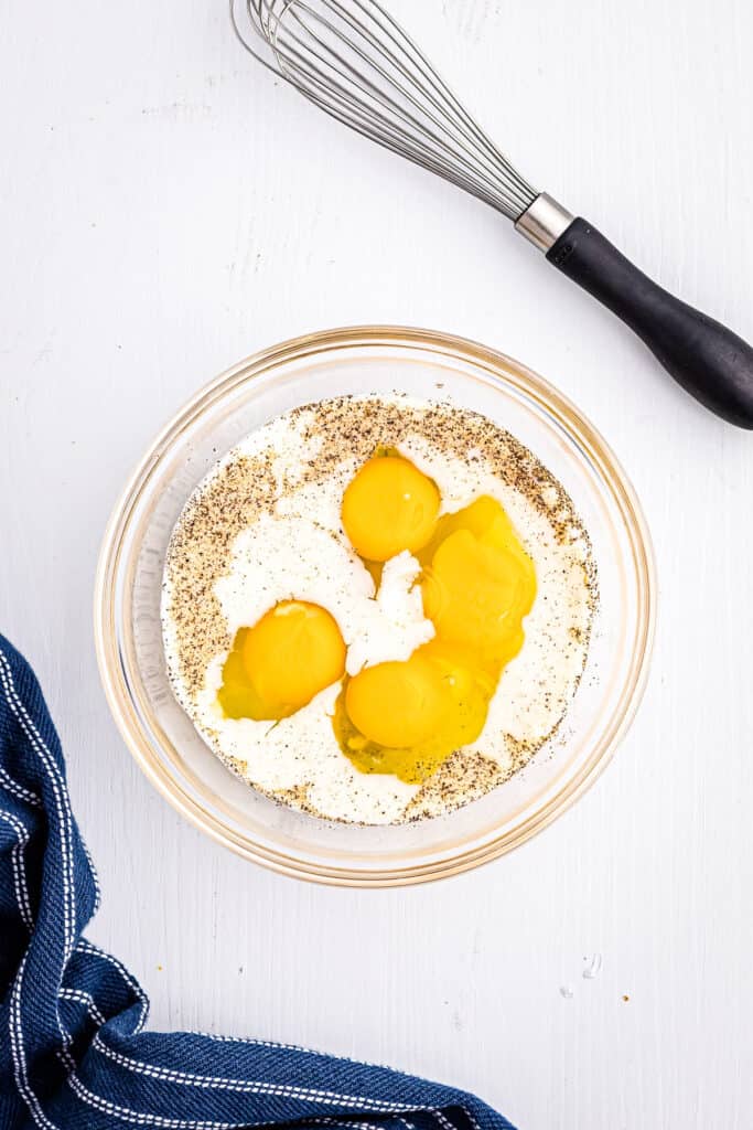 Glass bowl with milk, eggs to make scrambled eggs