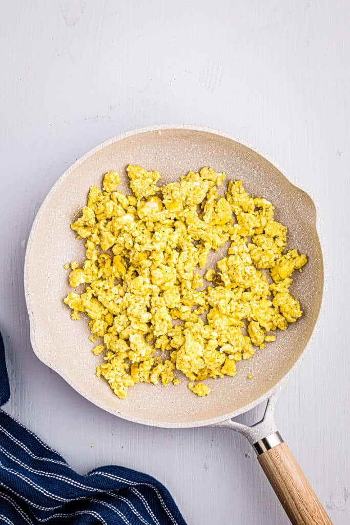 Pan with scrambled eggs in it.