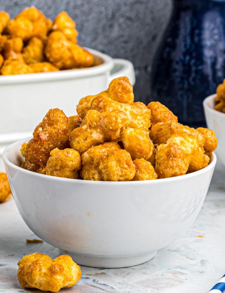 White Bowl with Caramel Puff Corn in it.