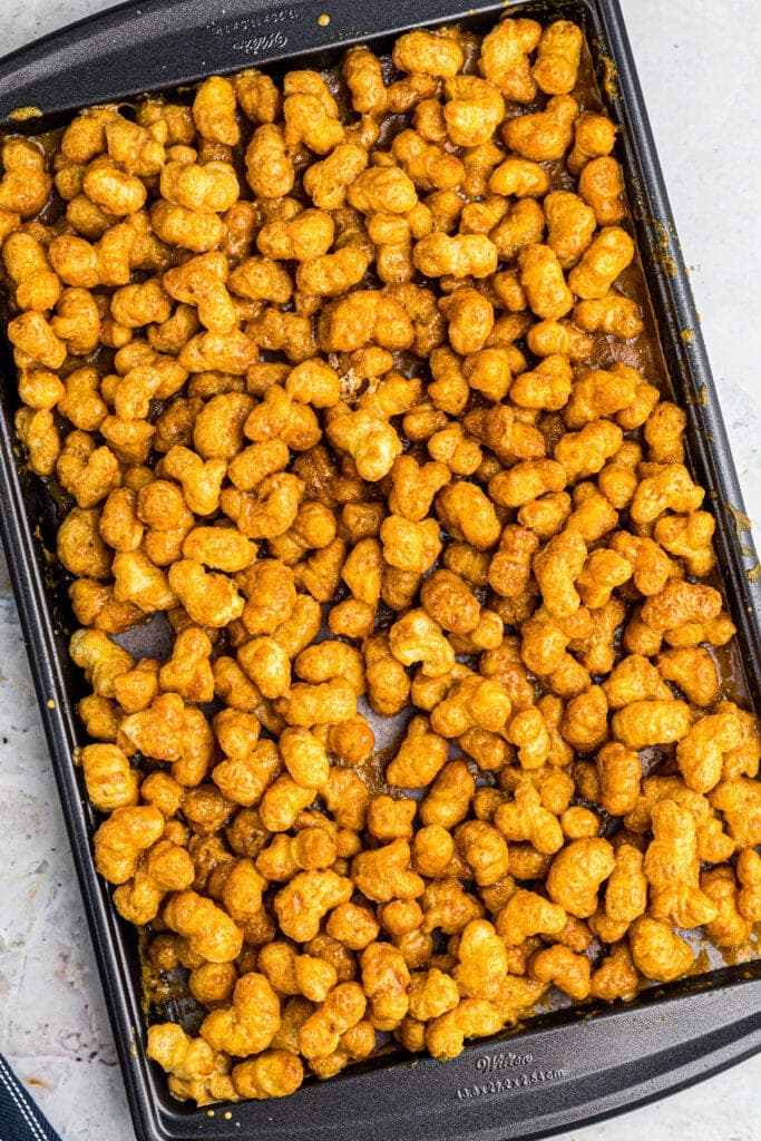 Overhead image of baking sheet with prepared Caramel Puff Corn