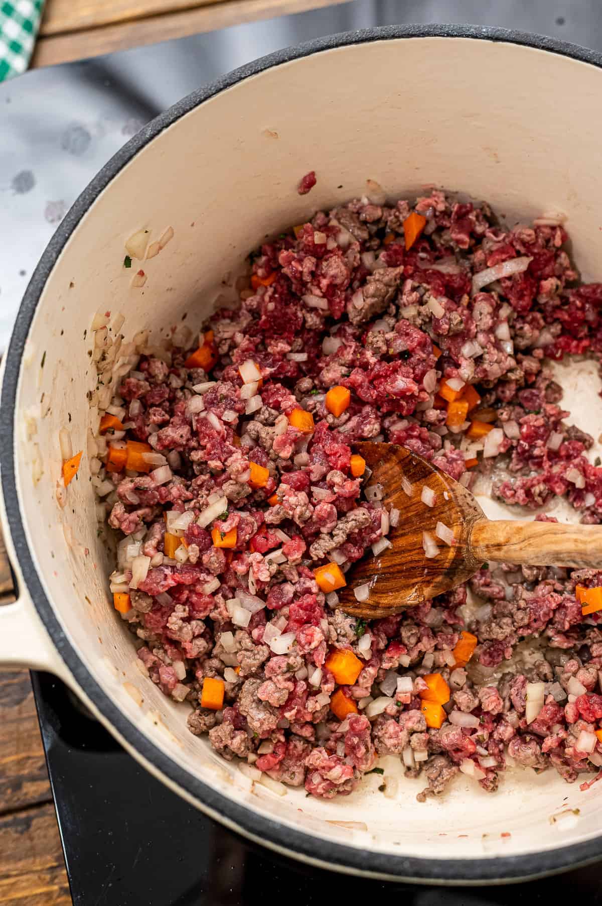 Browning ground beef and sauteing carrots in stock pot