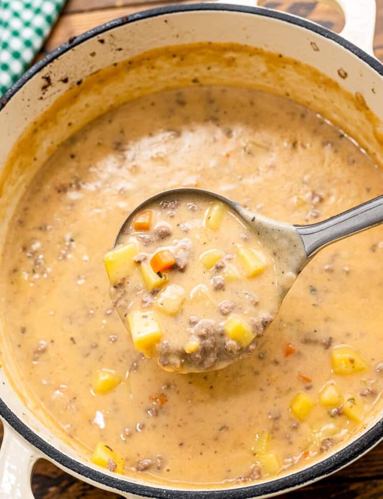 Ladle scooping Cheeseburger Soup out of pot