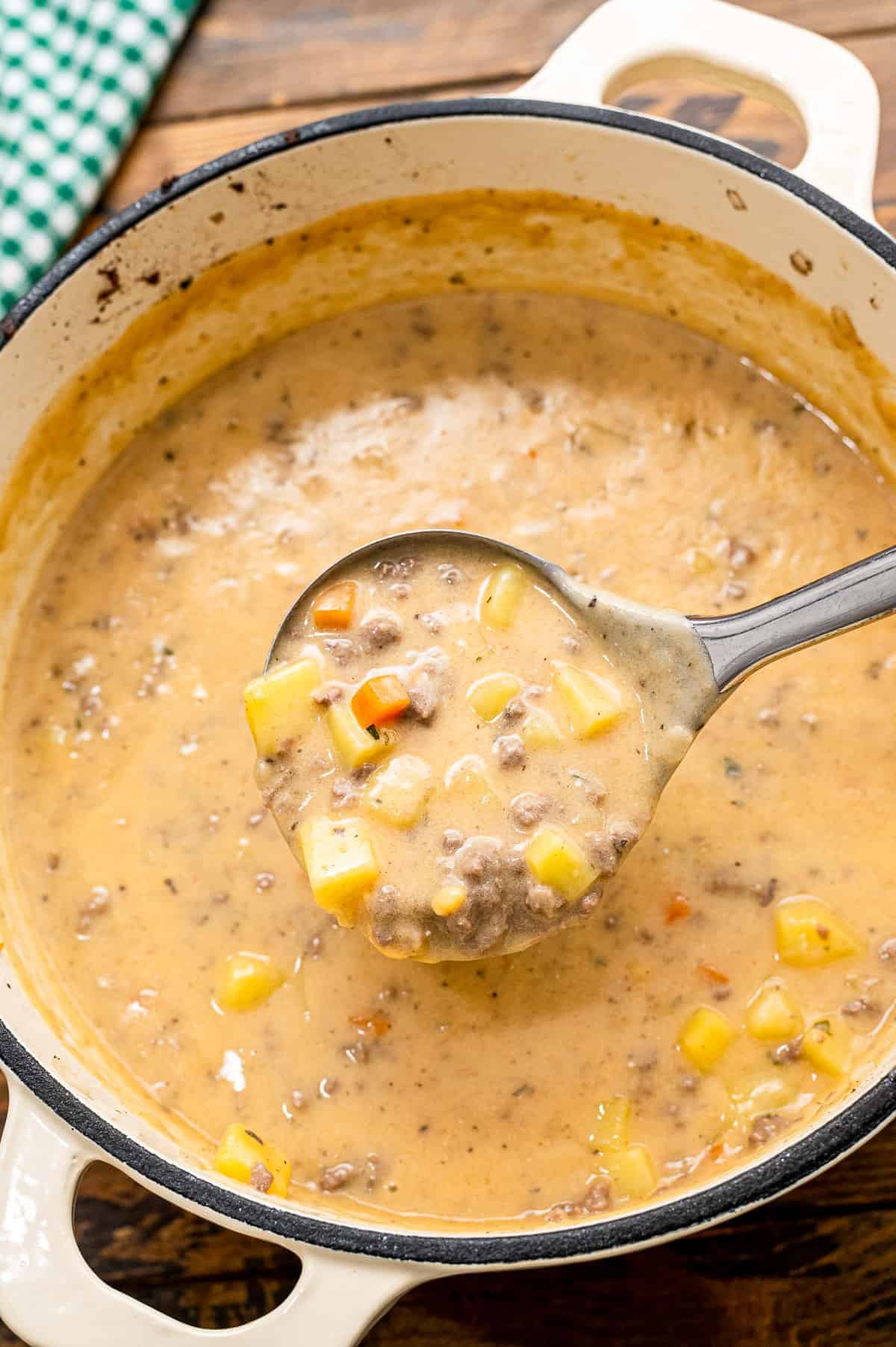 Ladle scooping Cheeseburger Soup out of pot