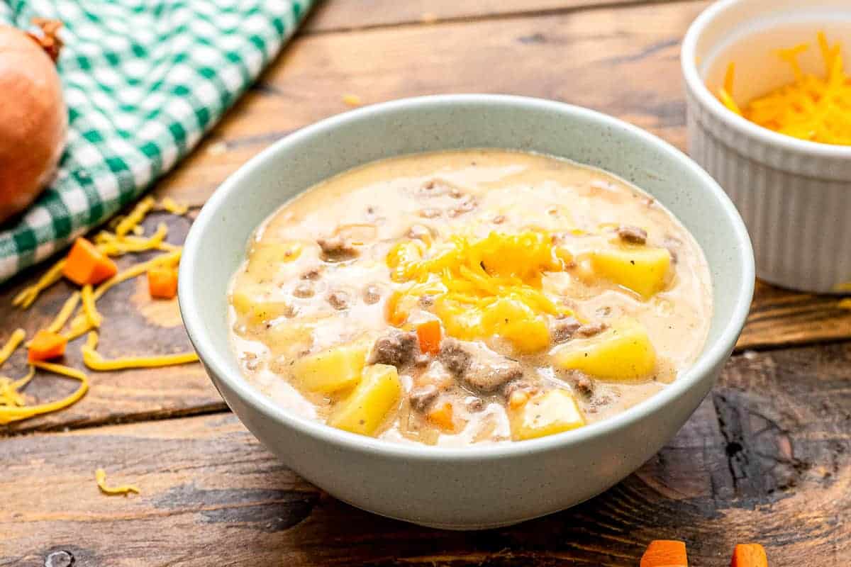 Bowl of cheeseburger soup on wooden background