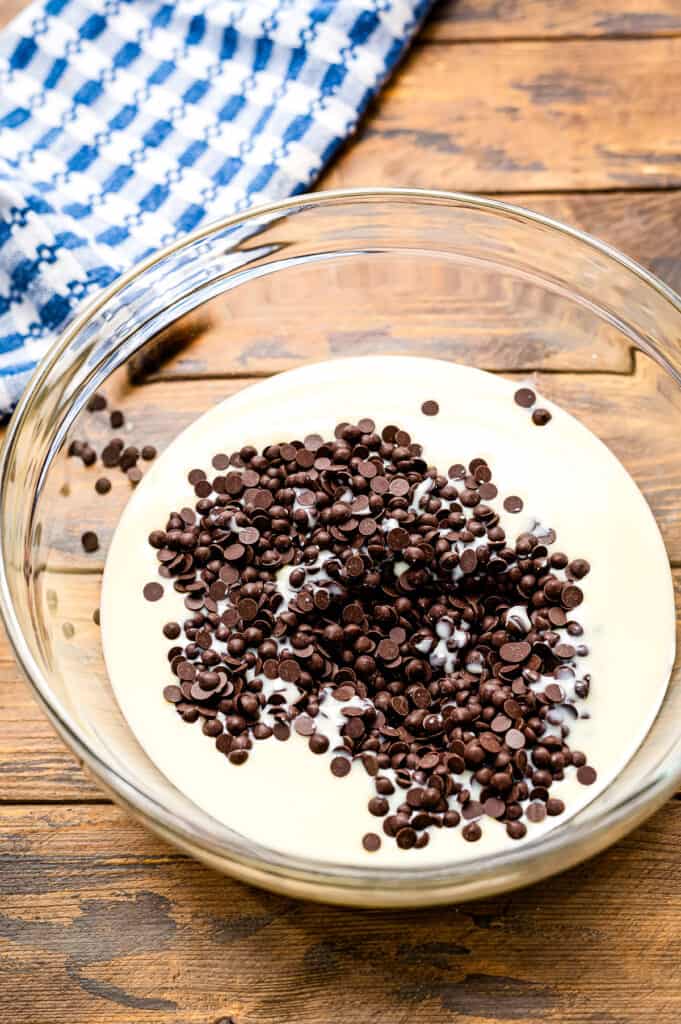 Glass bowl with chocolate chips and sweet and condensed milk