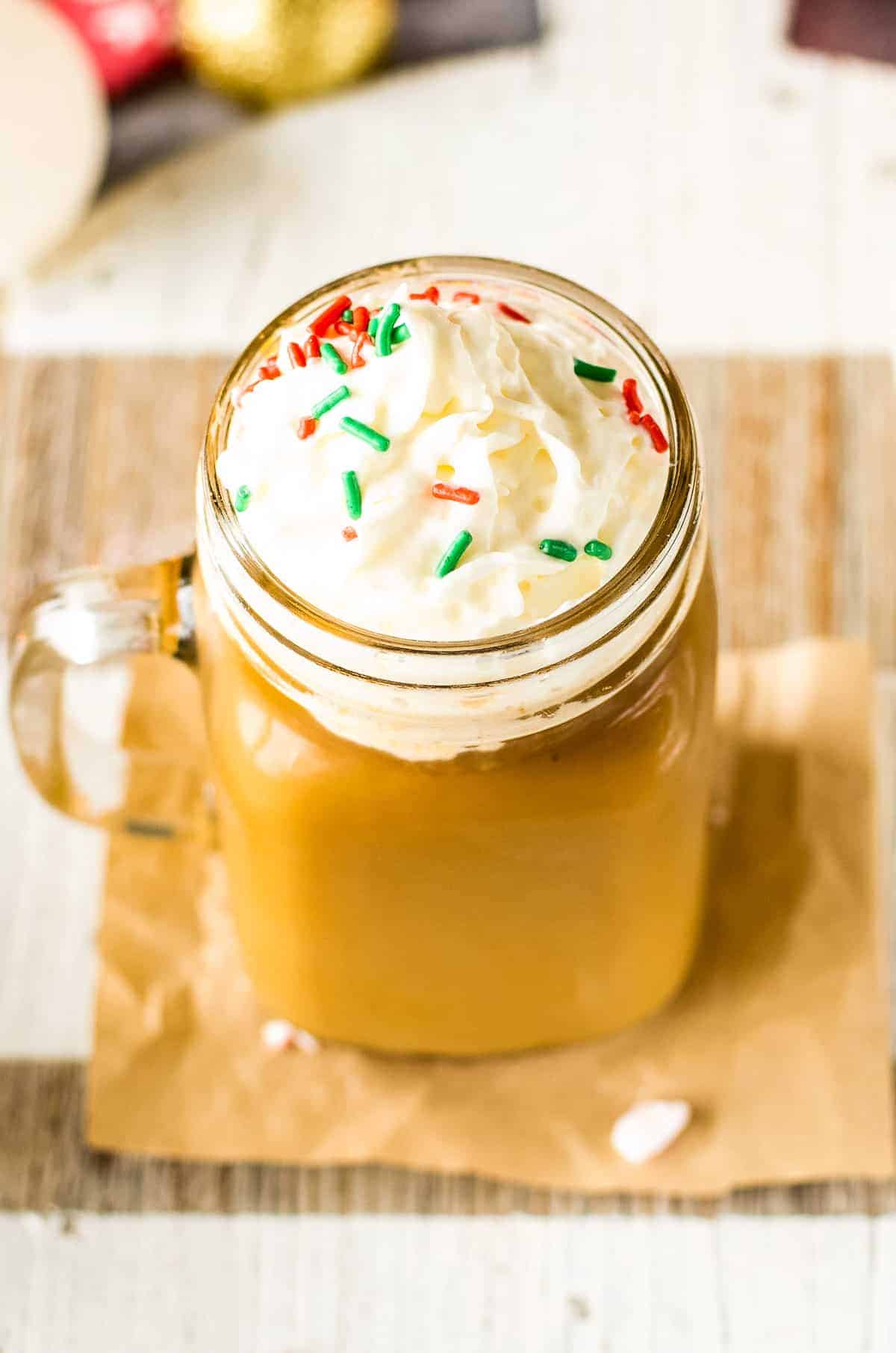 Overhead image of Christmas Coffee Topped with Whipped Cream and Red and Green Sprinkles