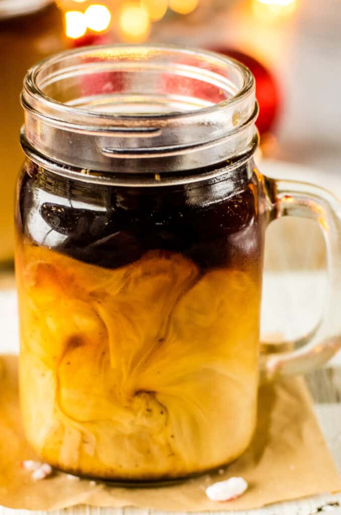 Christmas Coffee in glass mug swirled with milk