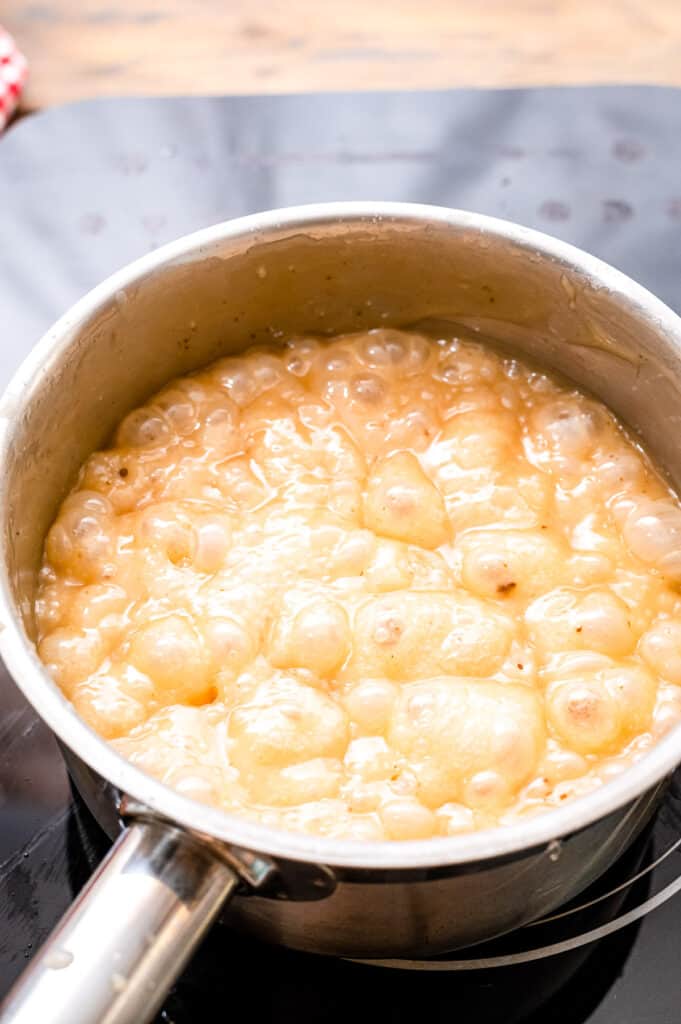 A saucepan boiling ingredients for homemade caramels