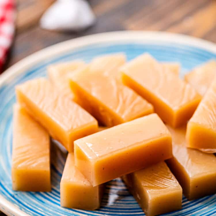 Pieces of homemade caramels on blue plate