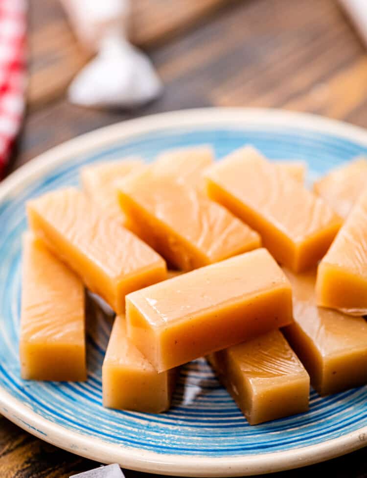 Pieces of homemade caramels on blue plate