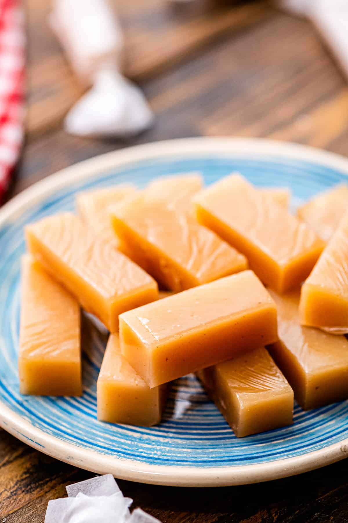 Pieces of homemade caramels on blue plate