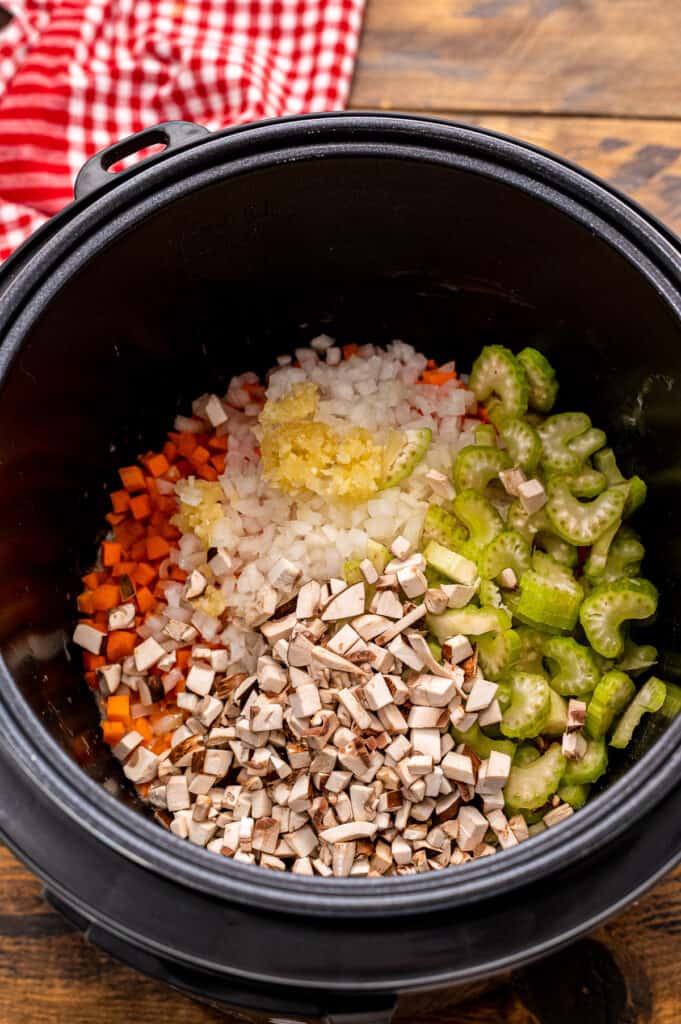 Instant Pot with ingredients for chicken wild rice soup before stirring.