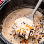 Instant Pot with a ladle scooping Chicken Wild Rice Soup out of it.