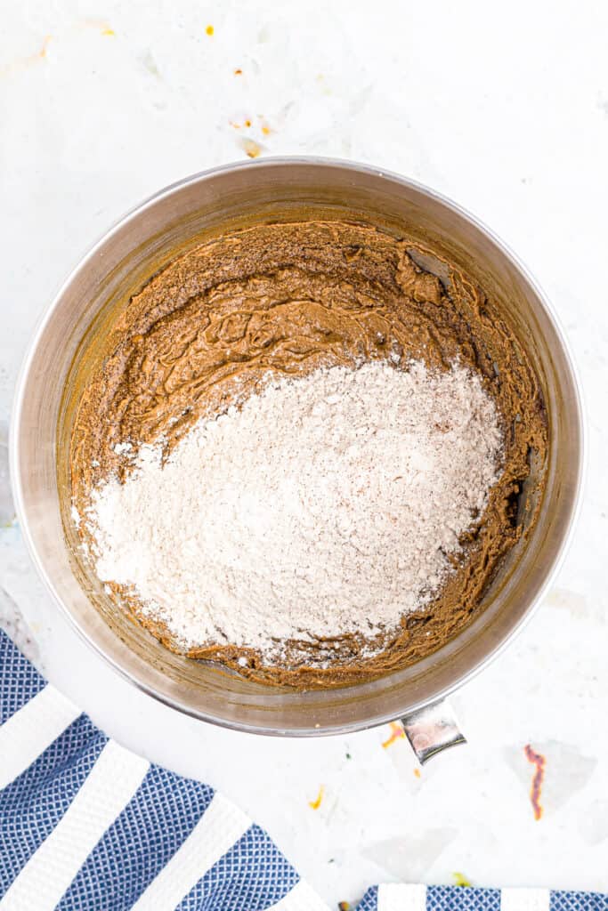 Overhead image of bowl with wet and dry ingredients for molasses cookies before mixing