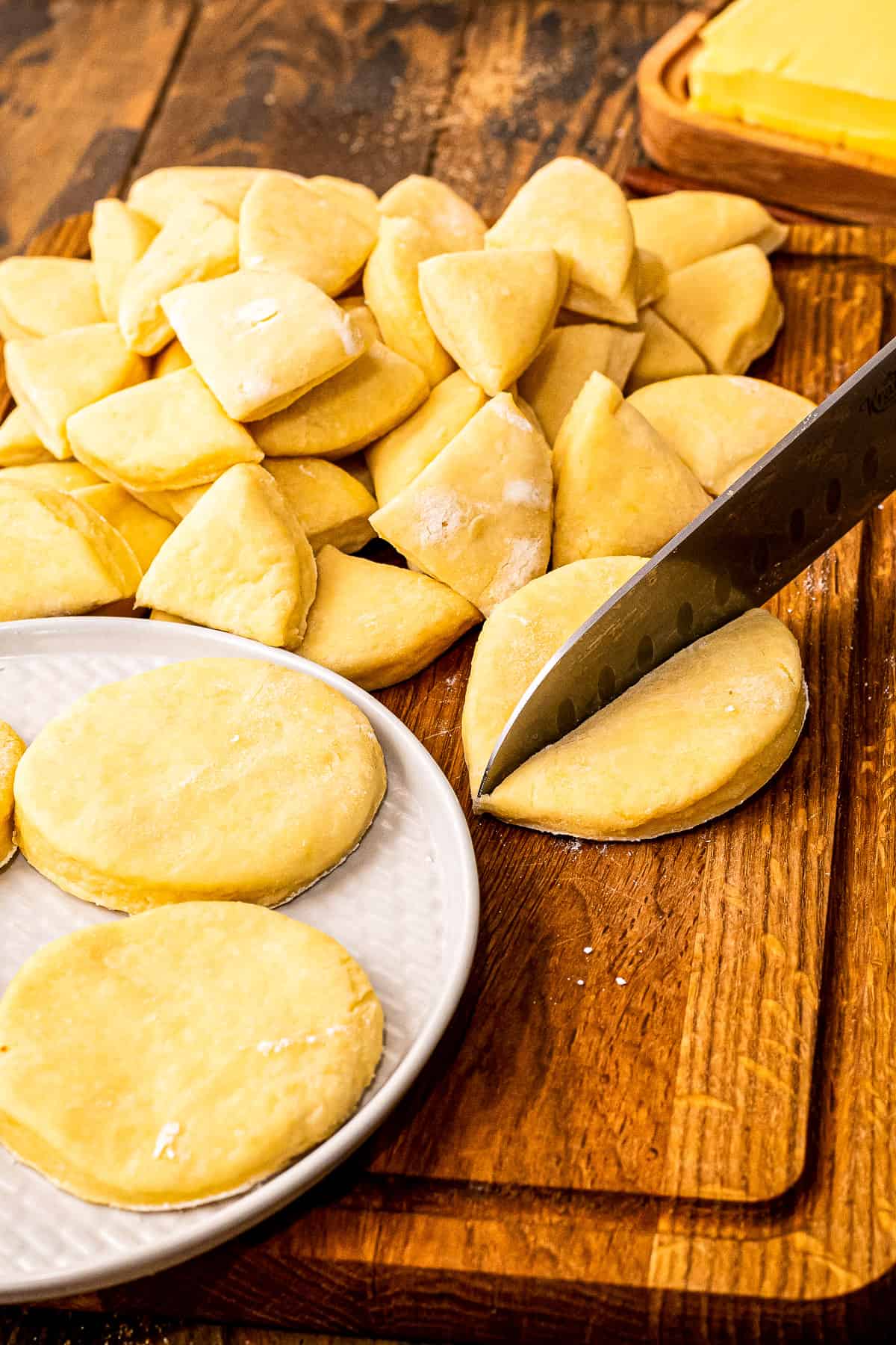 A chef knife cutting refrigerated biscuit