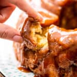 Finger pulling a piece of monkey bread out of pull aparts.