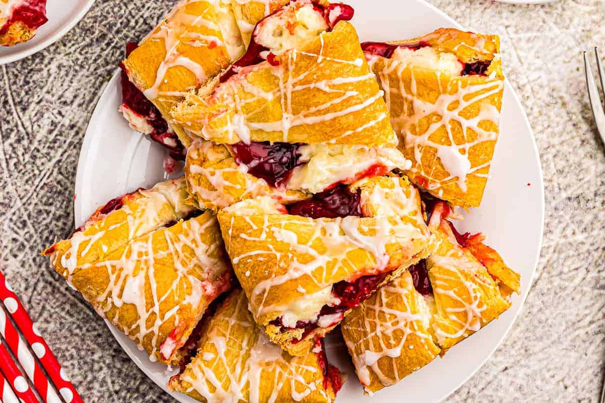 Overhead image of pieces of Strawberry Cheesecake Crescent Ring on plate