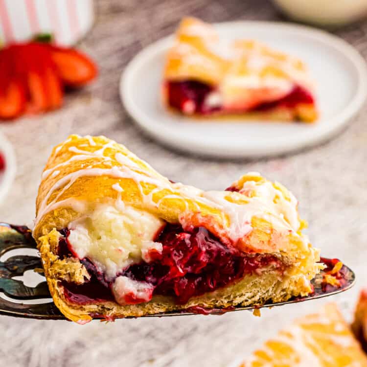 Slice of Strawberry Cheesecake Crescent Ring on spatula