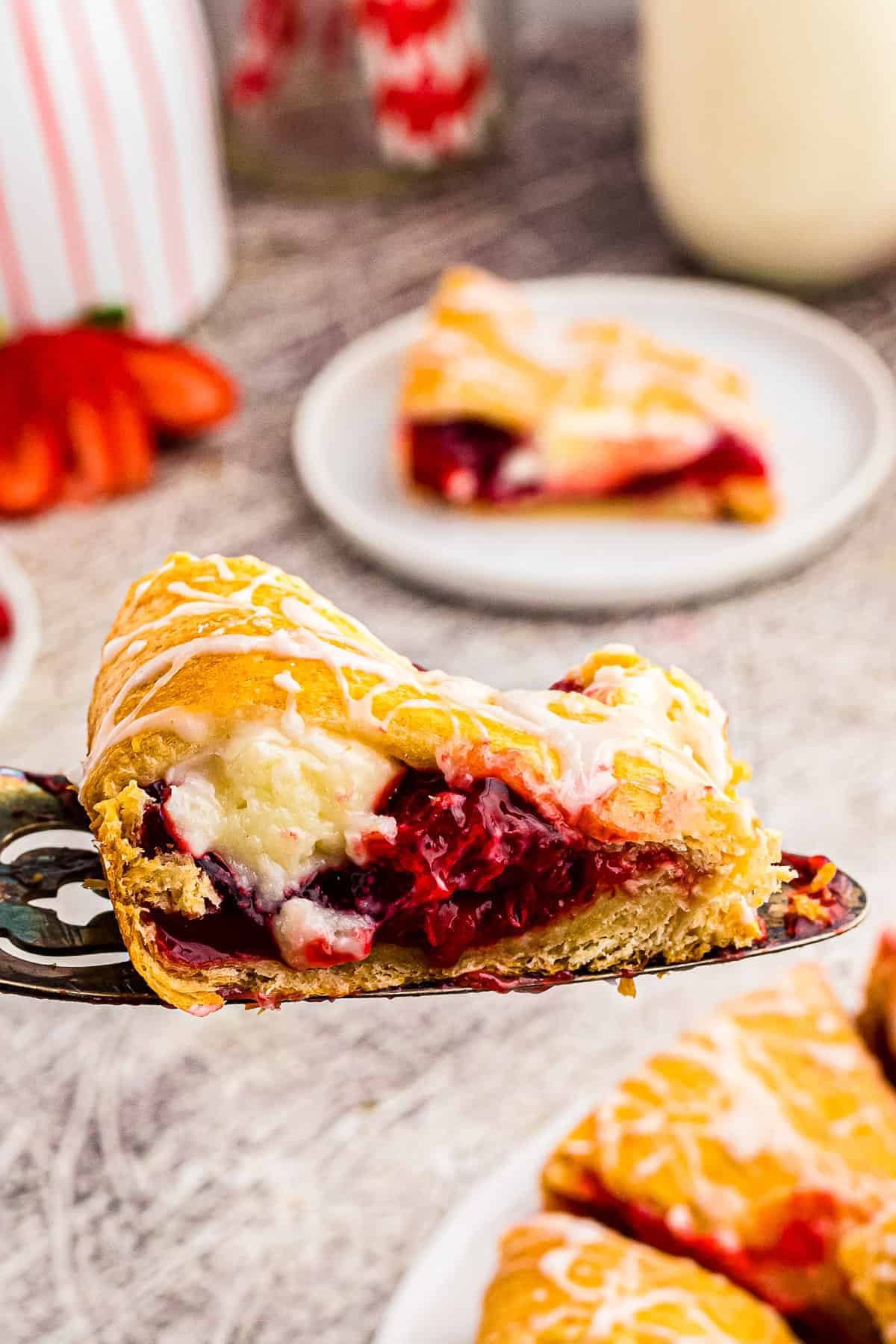 Slice of Strawberry Cheesecake Crescent Ring on spatula