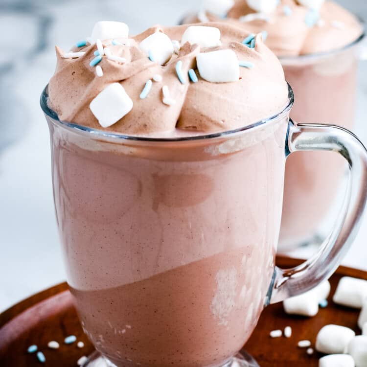 Mug full of Whipped Hot Chocolate topped with marshmallows and sprinkles